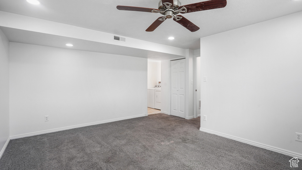 Carpeted empty room with recessed lighting, a ceiling fan, and separate washer and dryer