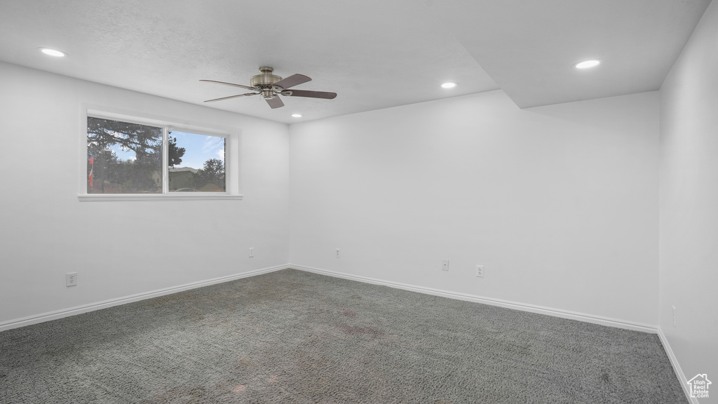 Unfurnished room with a ceiling fan, dark carpet, and recessed lighting