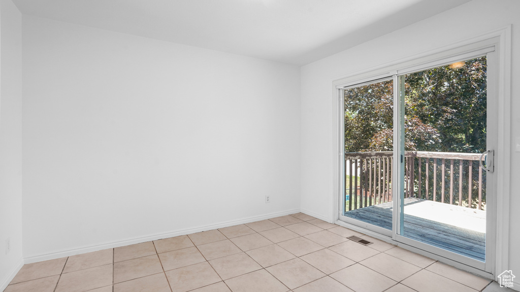 Spare room with baseboards and light tile patterned floors
