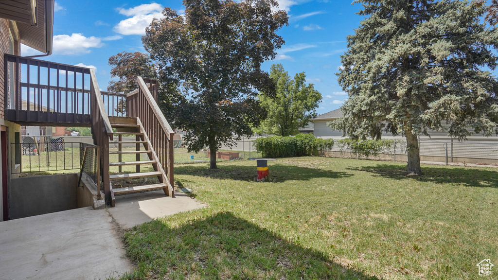 View of yard featuring stairs and a wooden deck