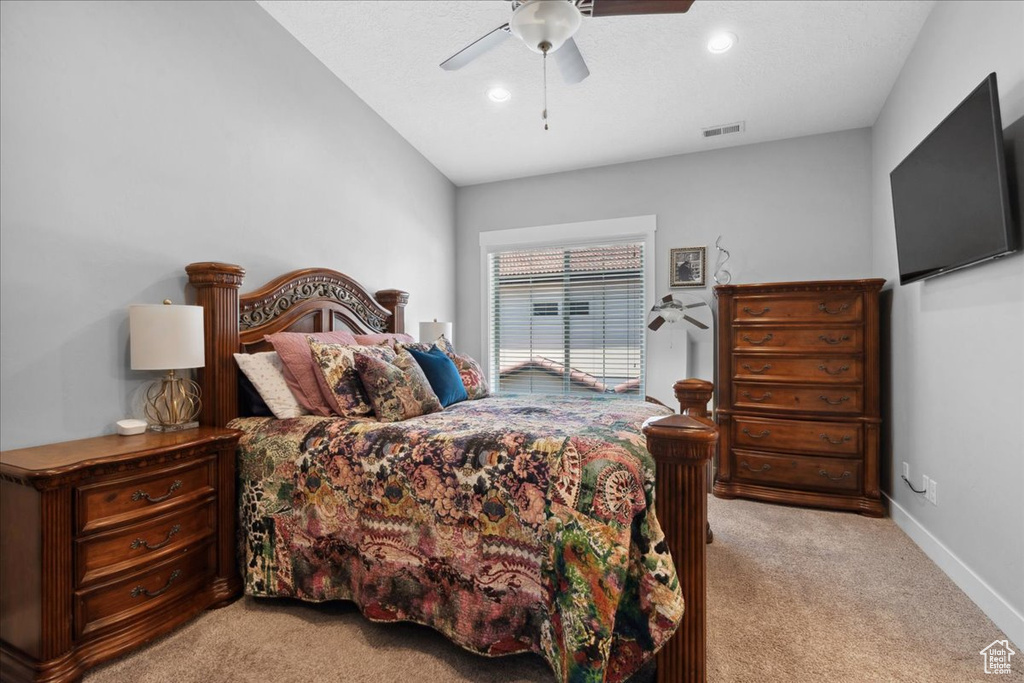 Bedroom featuring light carpet, ceiling fan, and recessed lighting