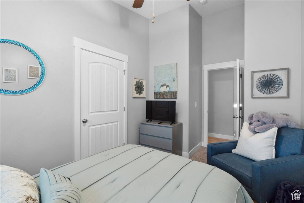 Carpeted bedroom with baseboards and ceiling fan