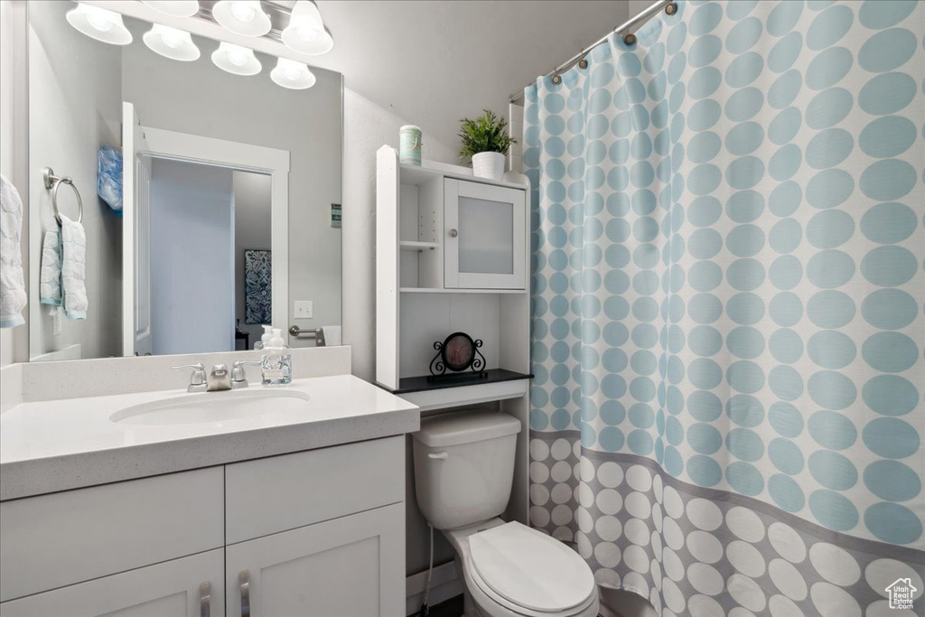 Full bath with vanity and a shower with curtain