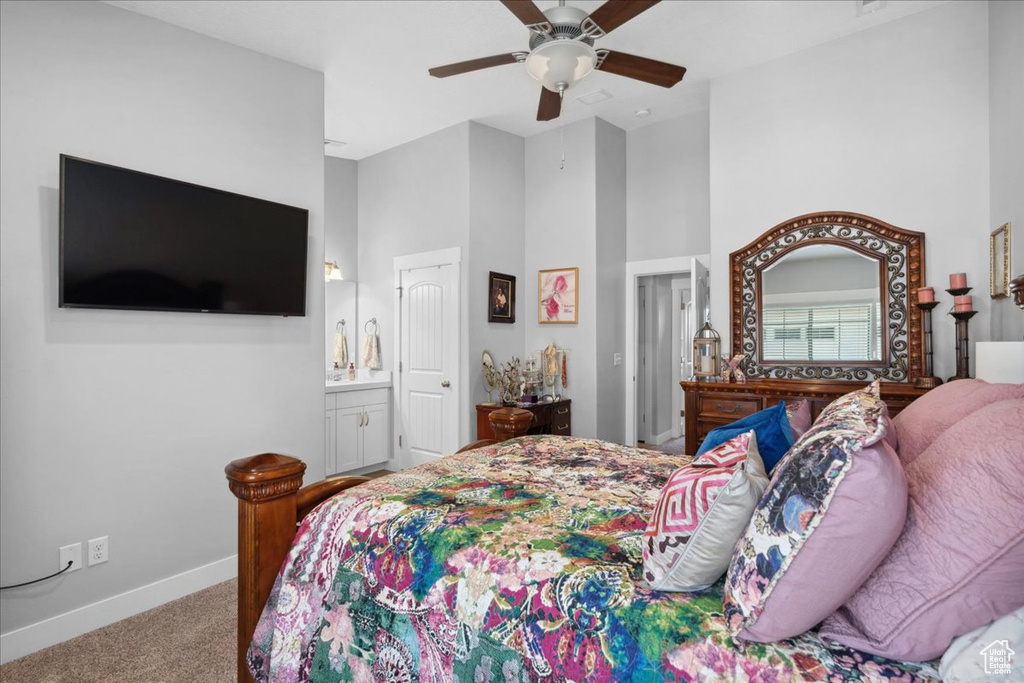 Bedroom with a high ceiling, carpet flooring, a ceiling fan, and ensuite bathroom