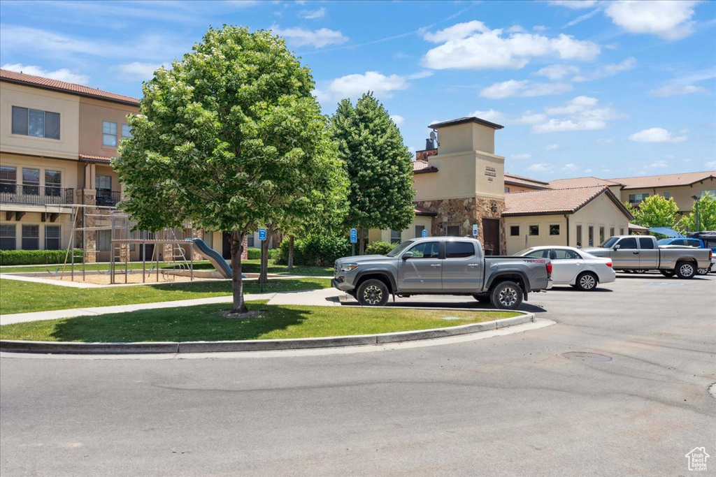 View of building exterior featuring uncovered parking