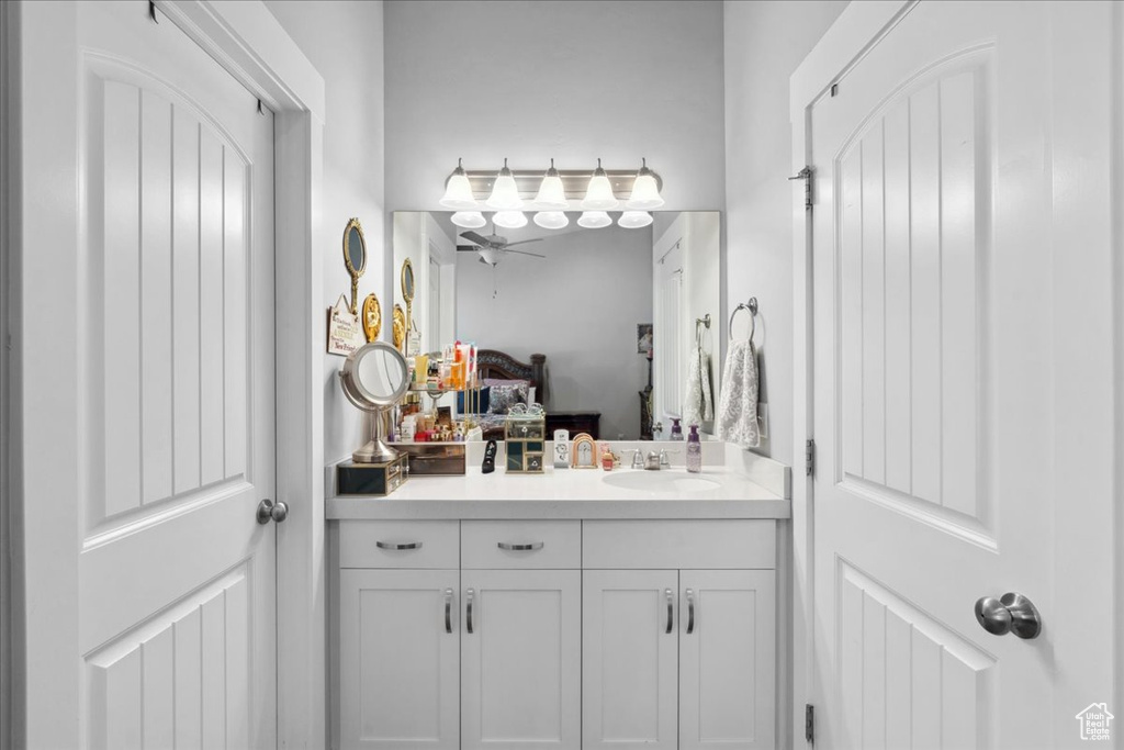 Bathroom with a ceiling fan, vanity, and connected bathroom