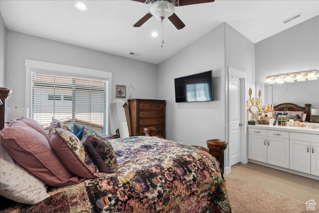 Bedroom with recessed lighting, lofted ceiling, ensuite bath, a ceiling fan, and light tile patterned flooring