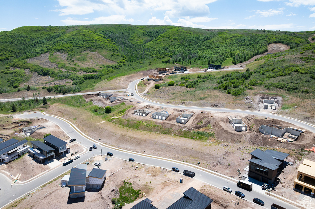 View of property location with a heavily wooded area