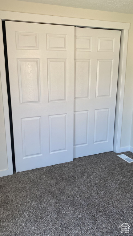 Unfurnished bedroom featuring carpet floors and a closet