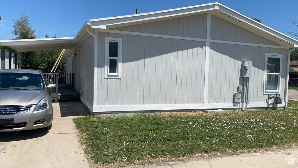 View of side of property featuring a lawn