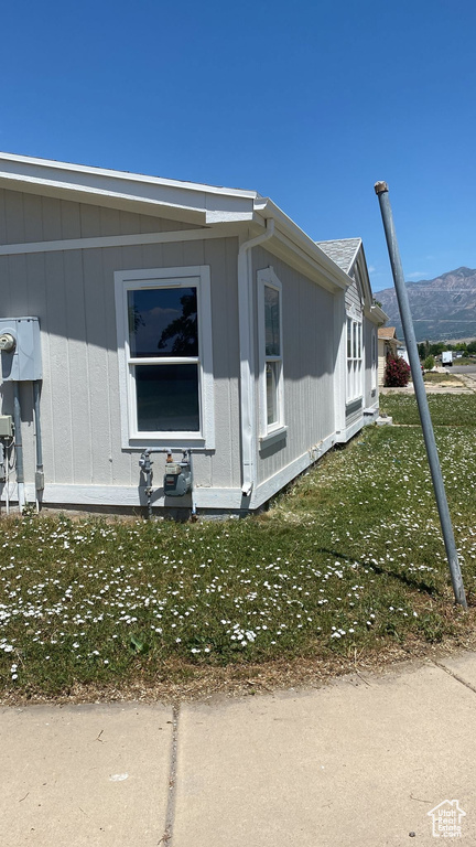 View of side of property with a mountain view