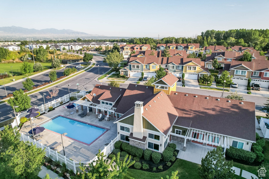 Aerial perspective of suburban area with a pool and mountains