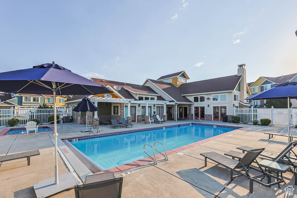 Community pool featuring a patio area, french doors, and a residential view