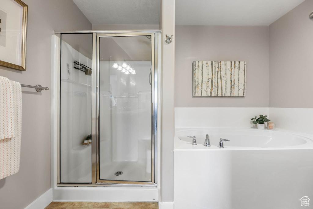 Full bath with a stall shower and a garden tub