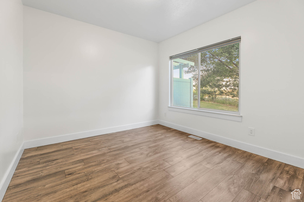 Empty room featuring wood finished floors and baseboards