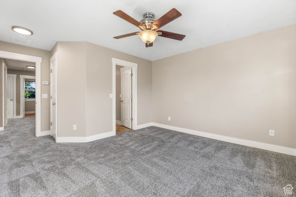 Unfurnished bedroom with carpet and a ceiling fan