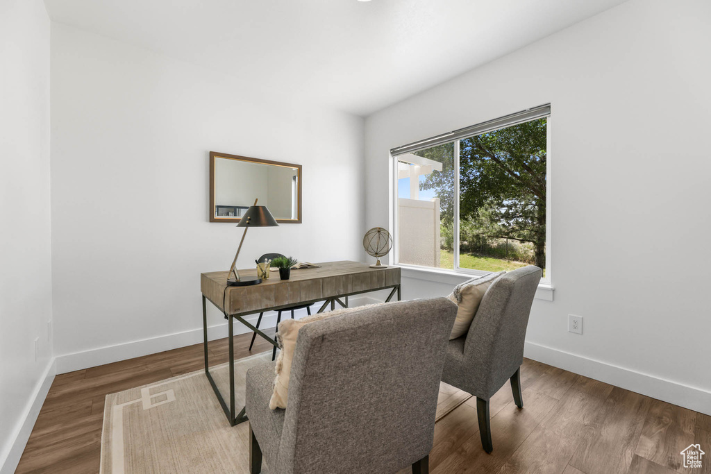 Office space with baseboards and wood finished floors