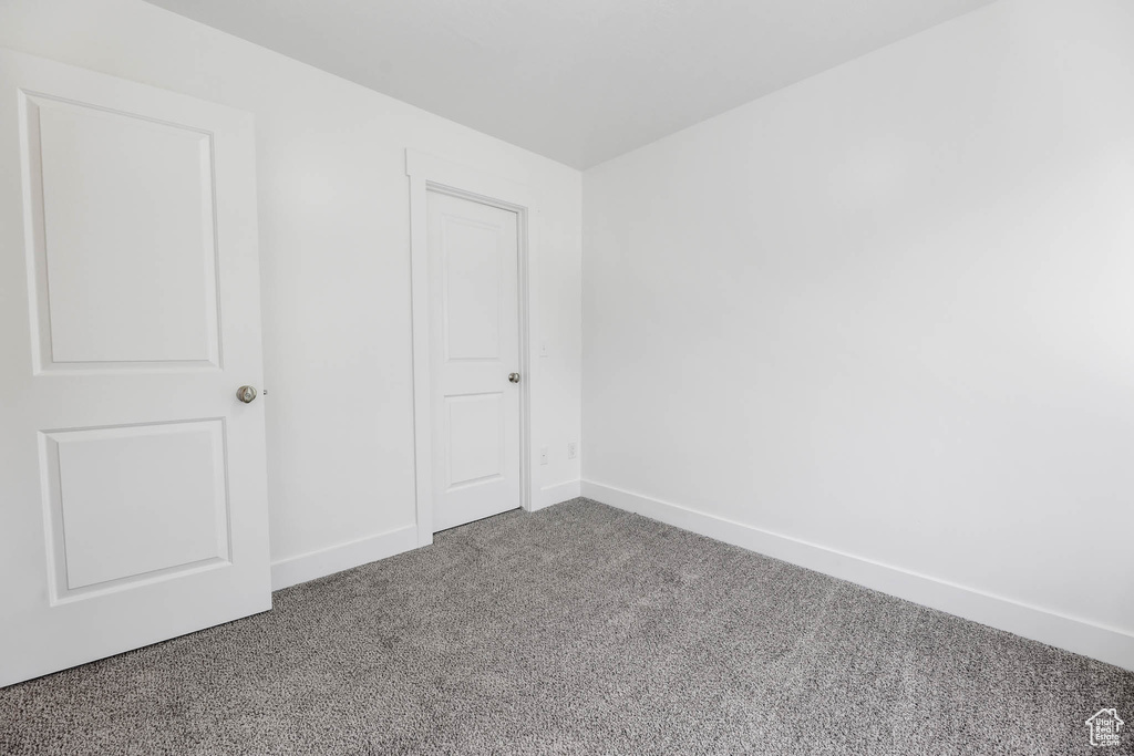 Unfurnished bedroom featuring carpet and baseboards