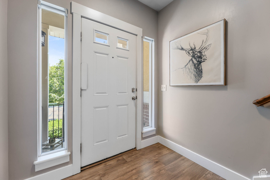 Entrance foyer featuring baseboards and wood finished floors