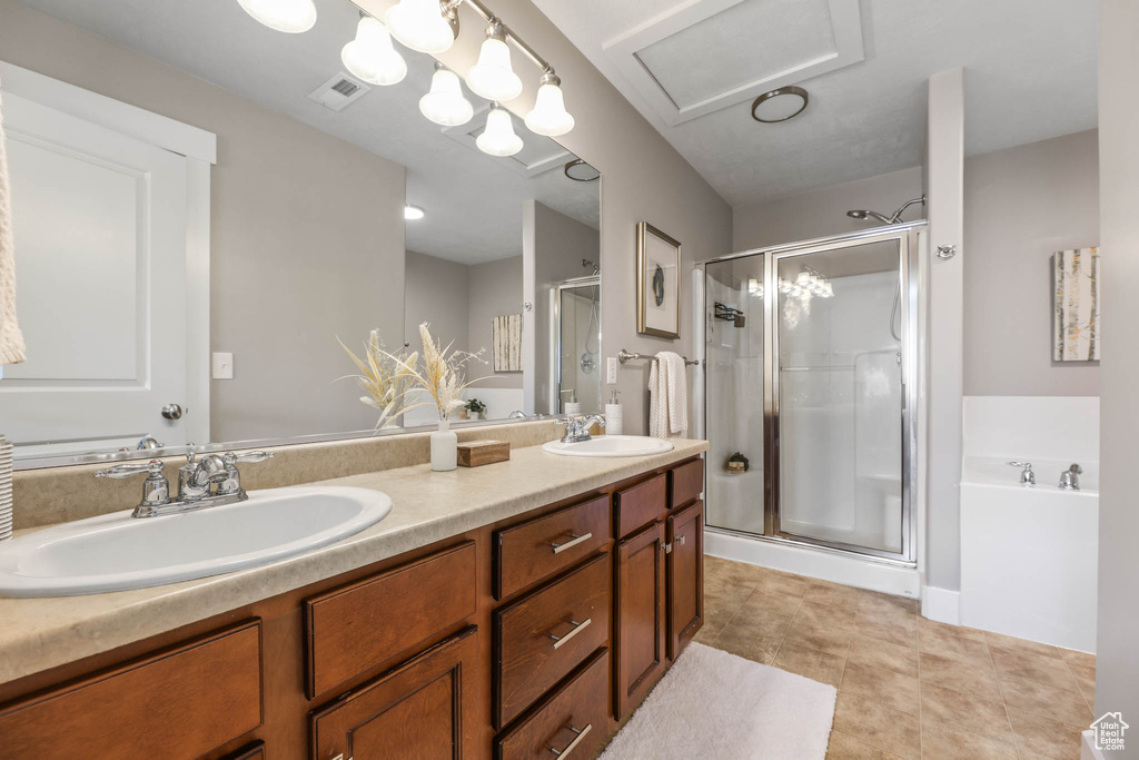 Bathroom with a shower stall, double vanity, and a bath