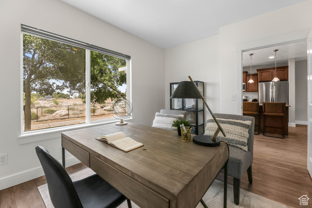 Dining space featuring baseboards and wood finished floors