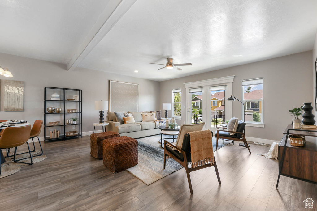 Living room featuring ceiling fan, wood finished floors, and beamed ceiling