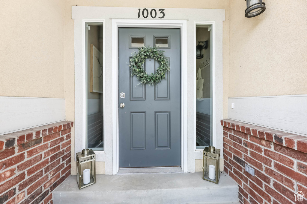 Entrance to property featuring stucco siding