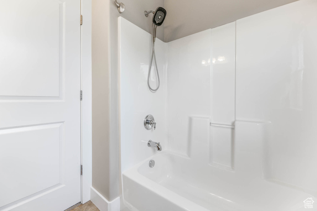 Full bath with tub / shower combination and baseboards
