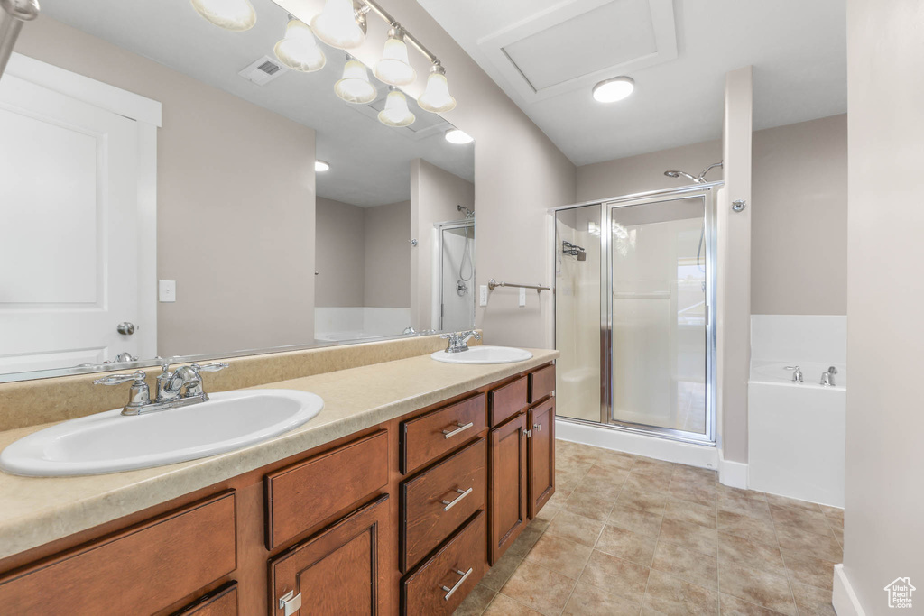 Bathroom with a shower stall, a garden tub, and double vanity