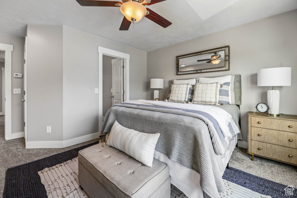 Carpeted bedroom with baseboards and ceiling fan
