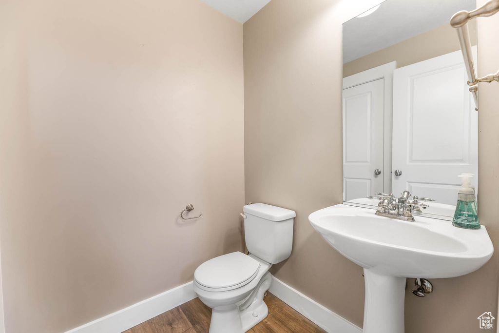 Bathroom with baseboards and wood finished floors