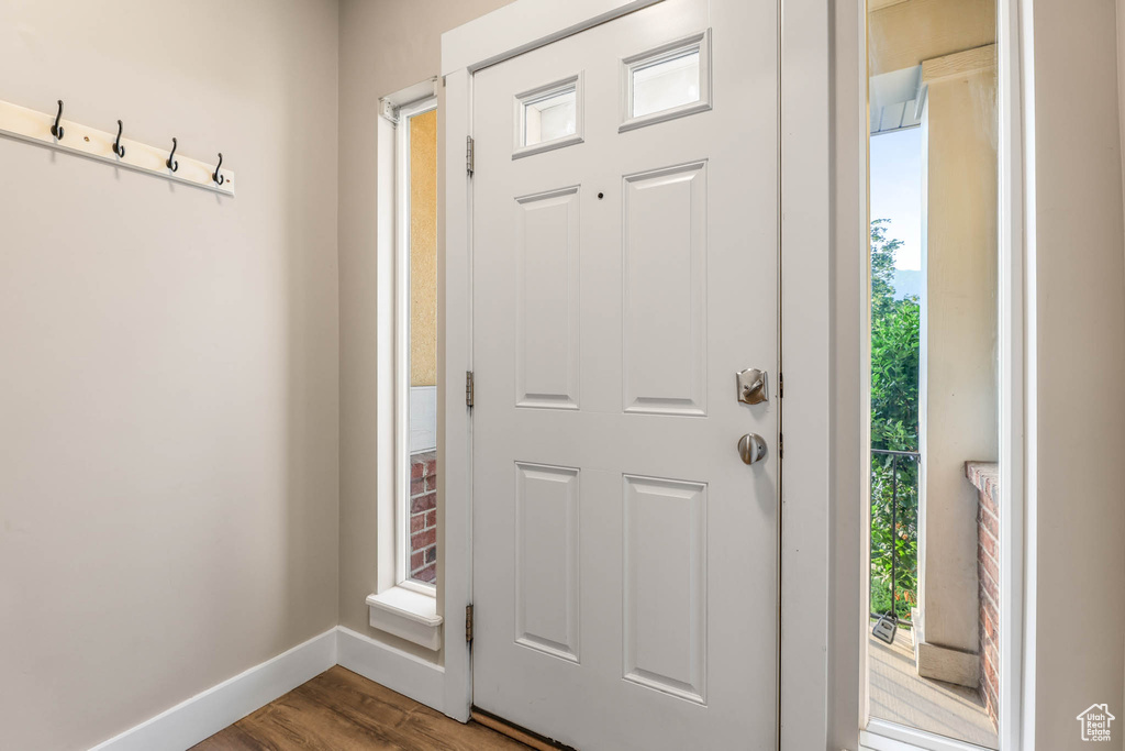 Entryway featuring baseboards and wood finished floors
