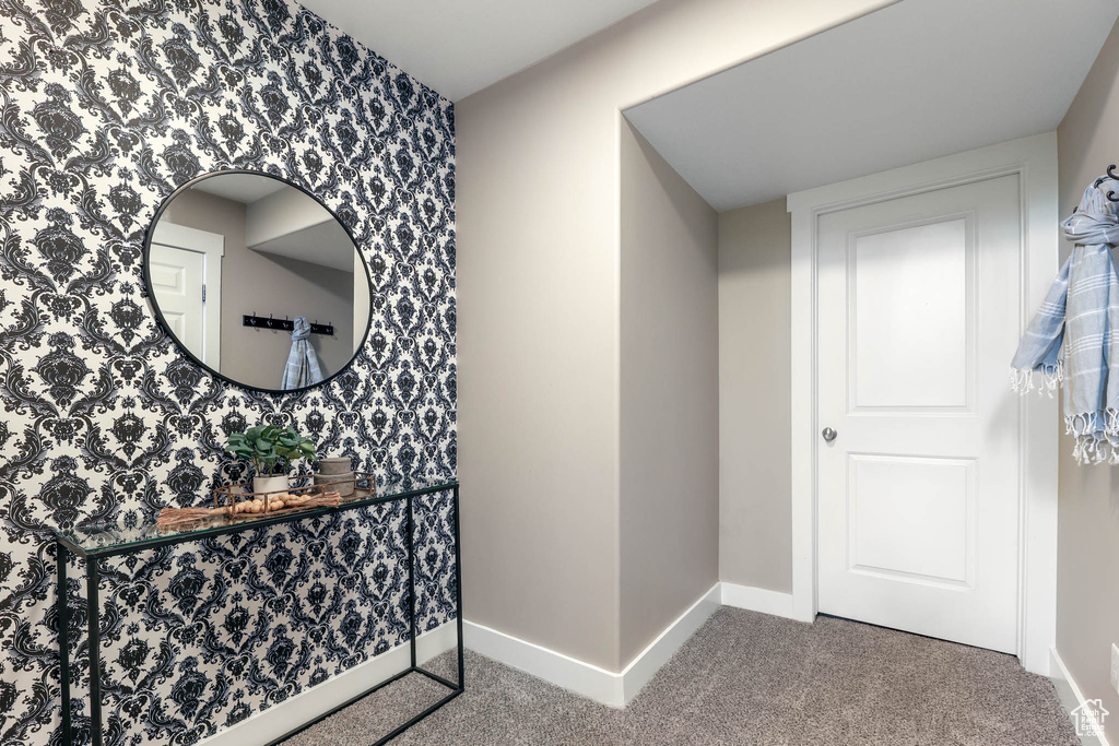 Hall with carpet and wallpapered walls
