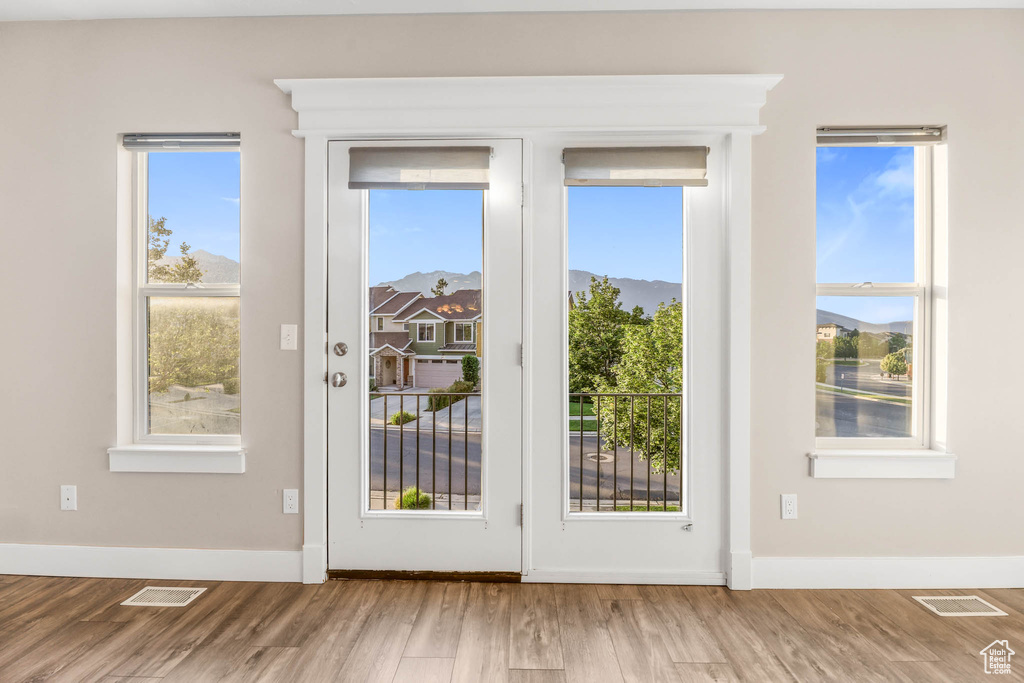 Doorway featuring wood finished floors and baseboards