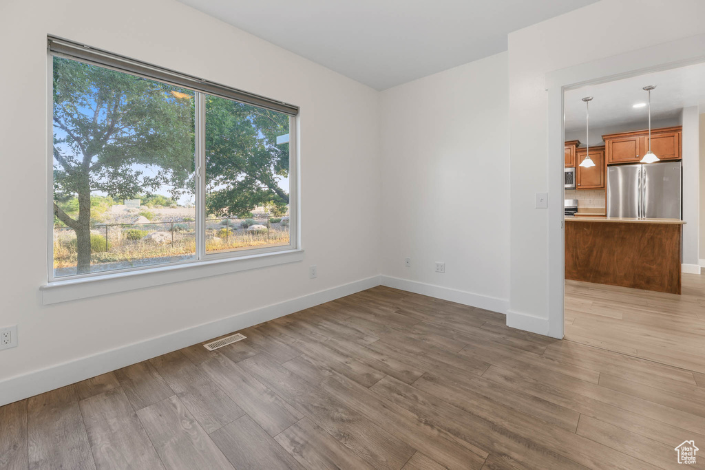Unfurnished living room featuring plenty of natural light and wood finished floors
