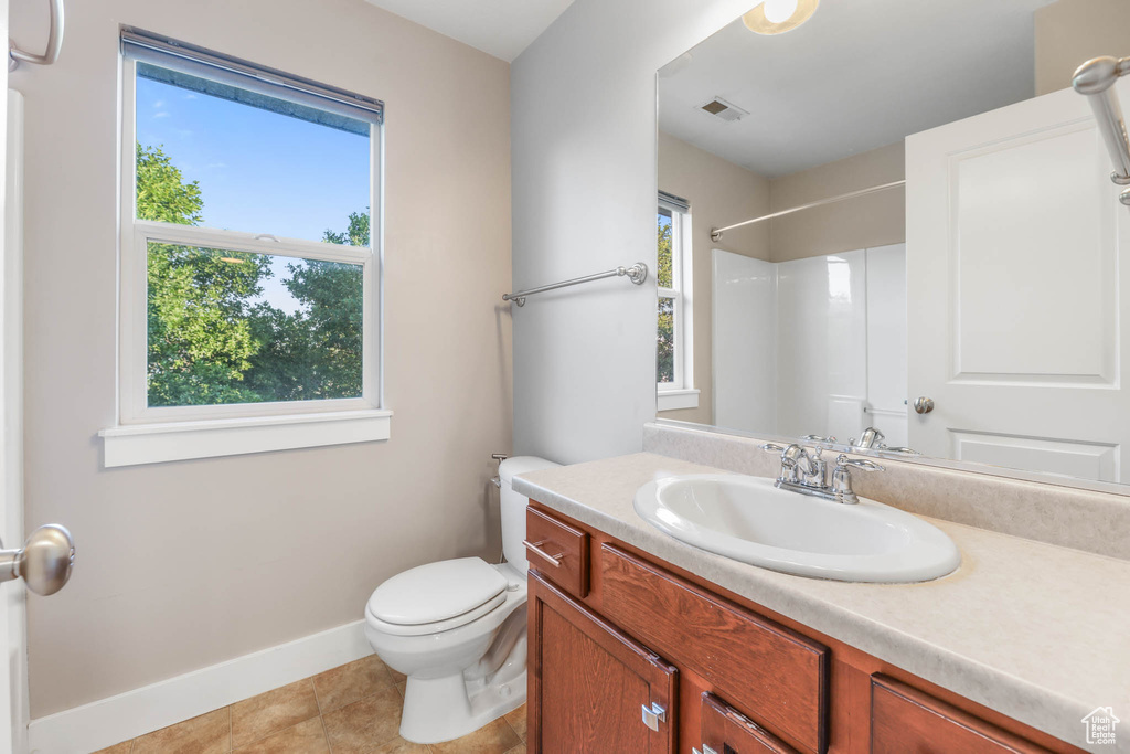 Full bathroom with vanity, a shower, and tile patterned flooring