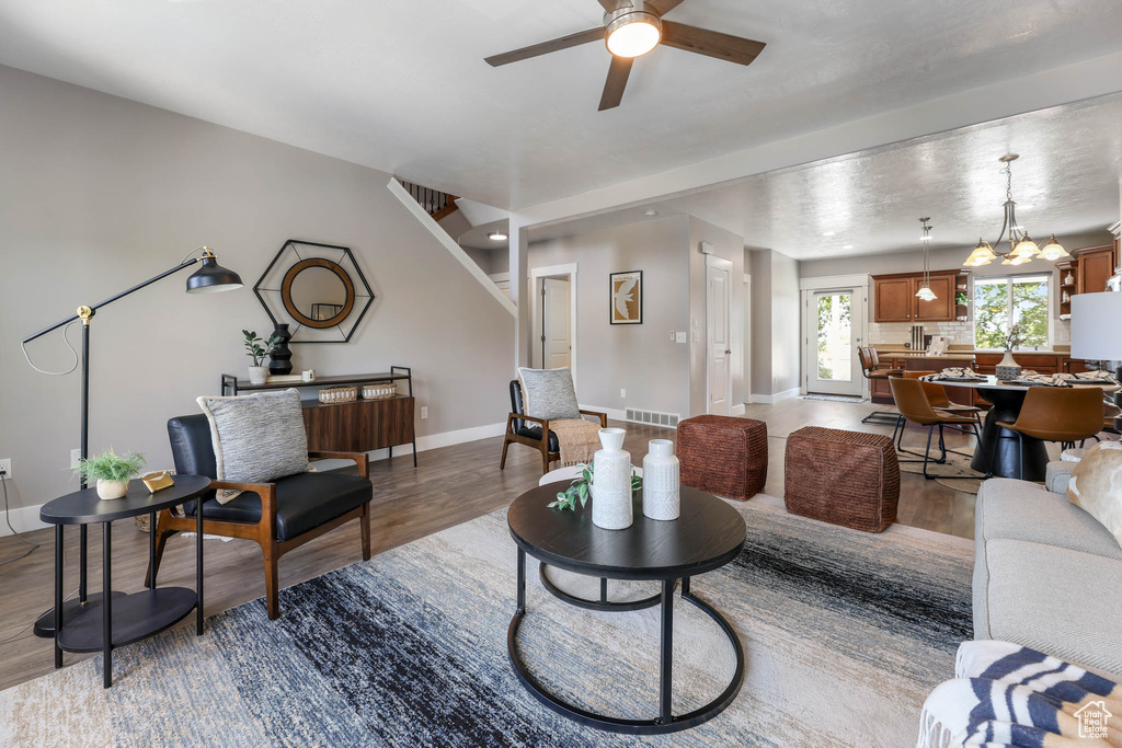 Living area featuring wood finished floors and a ceiling fan