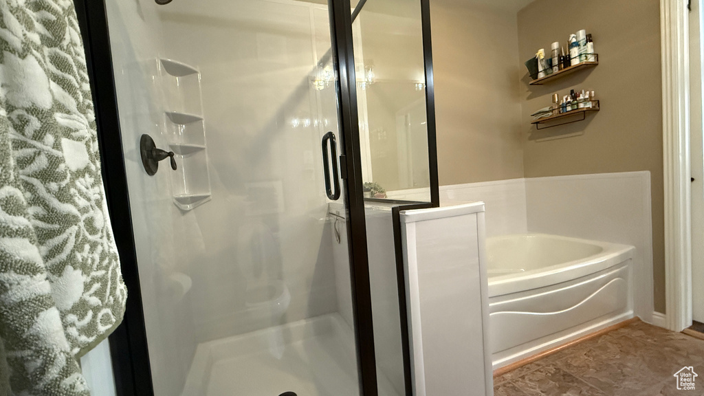 Full bathroom featuring a bath and a stall shower