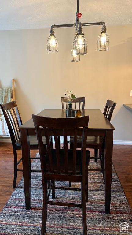 Dining area with wood finished floors and a textured ceiling