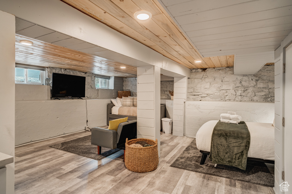 Basement with wooden ceiling and wood finished floors
