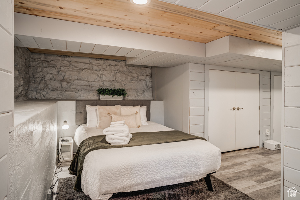 Bedroom featuring wood ceiling and wood finished floors