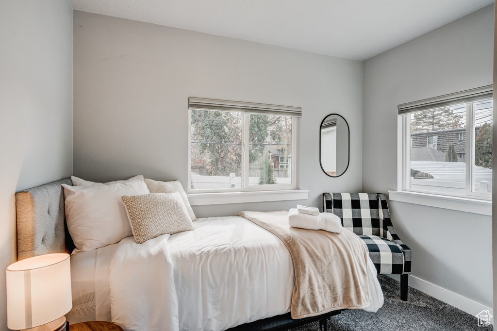 Bedroom featuring carpet flooring and baseboards
