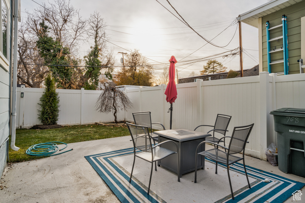 Fenced backyard featuring a patio area and an outdoor fire pit