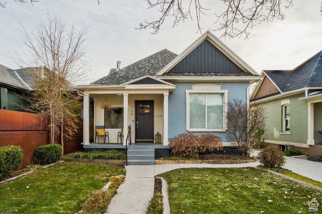 Bungalow-style home with board and batten siding and a porch