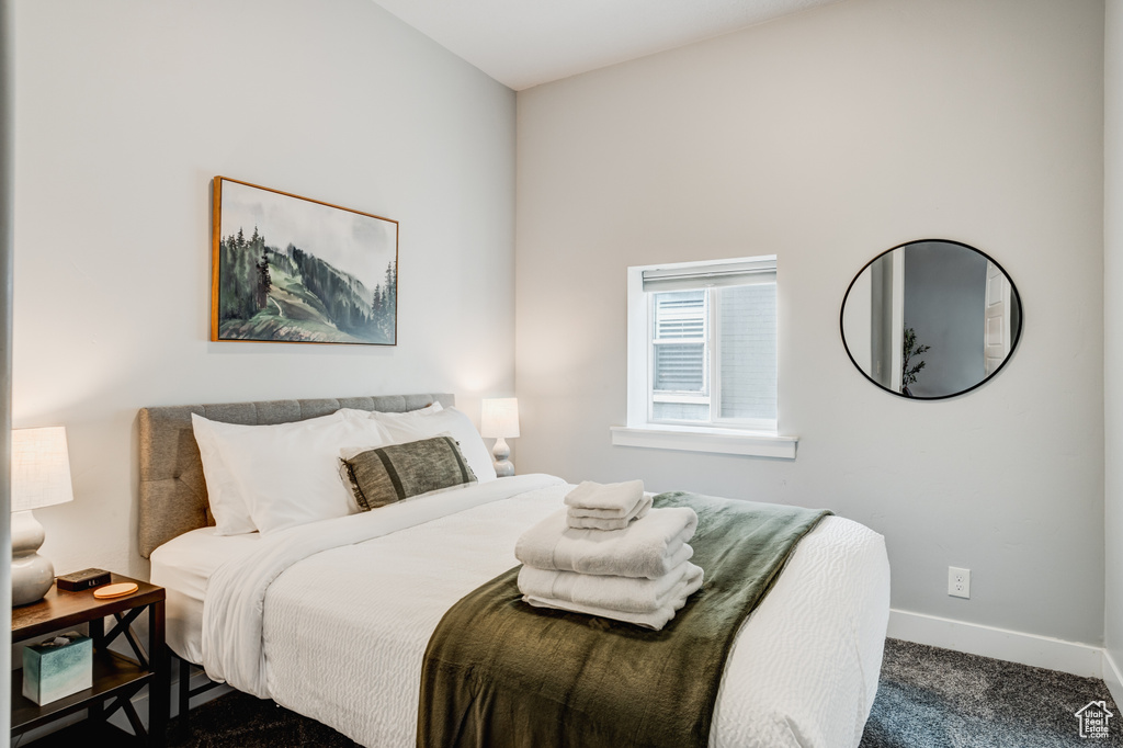 Bedroom with carpet flooring and baseboards