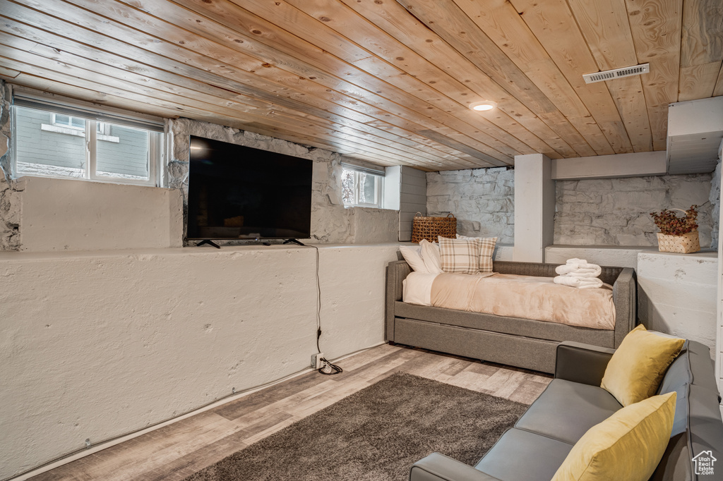 Living room with wooden ceiling and wood finished floors