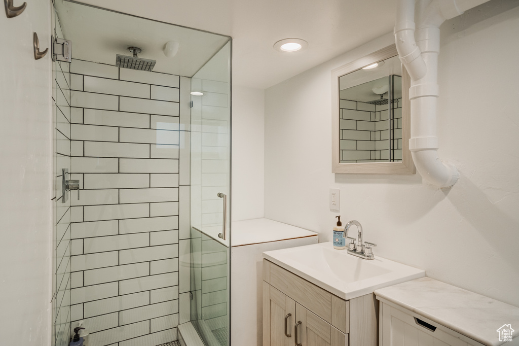 Full bath with a stall shower and vanity