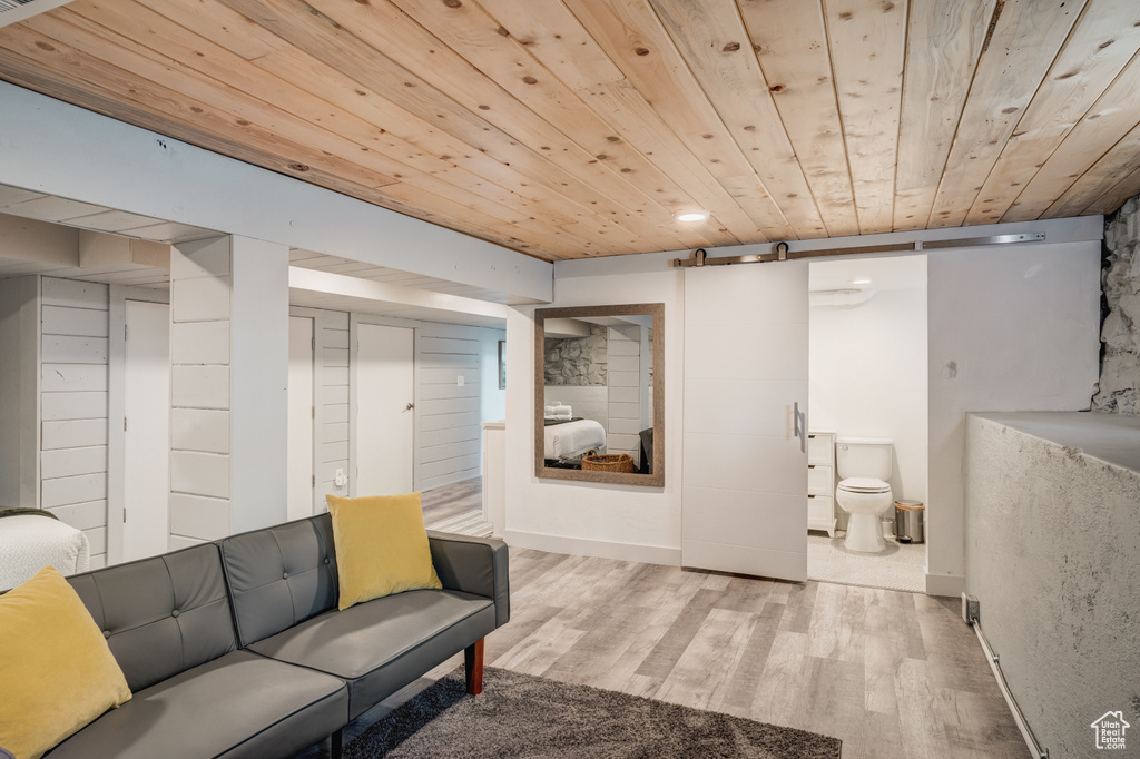 Finished basement with wooden ceiling, wood finished floors, and recessed lighting