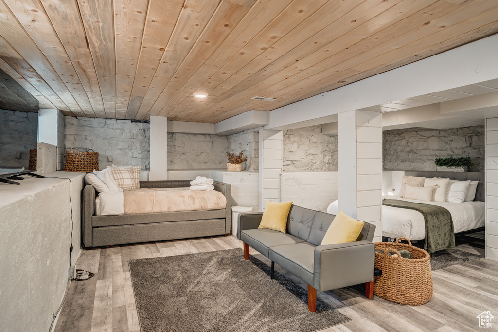 Bedroom with wooden ceiling and wood finished floors