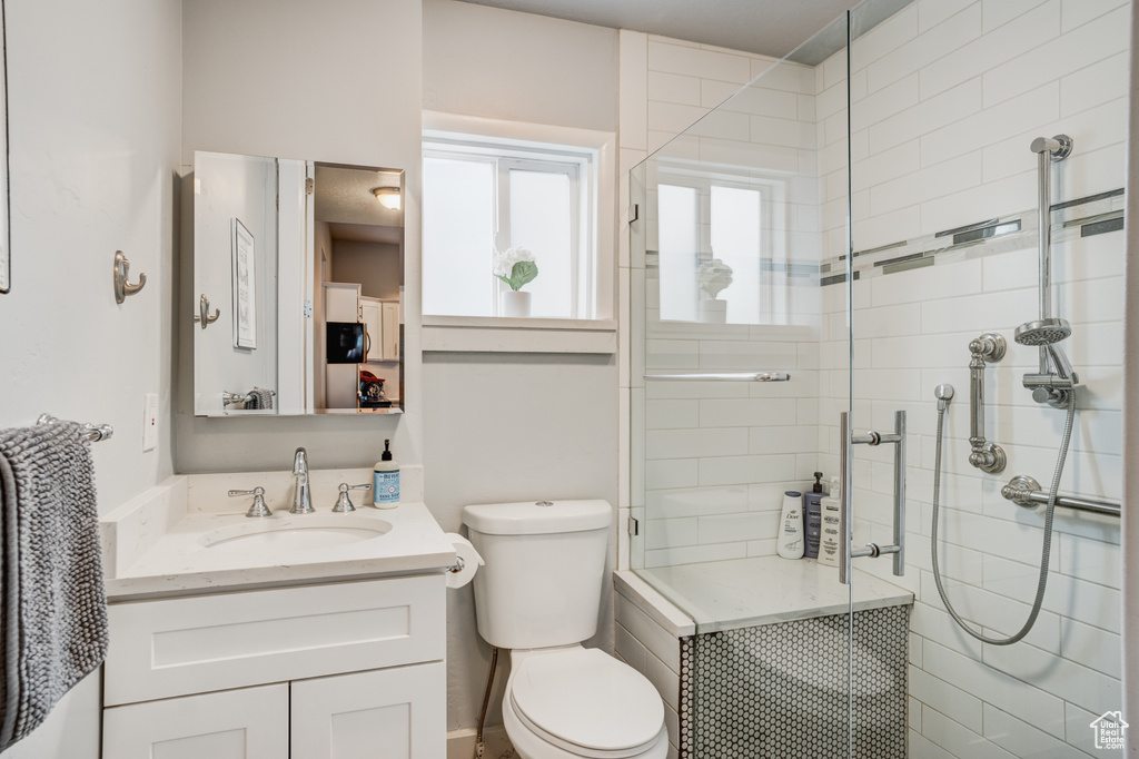 Full bathroom with vanity and a shower stall